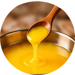 Golden ghee from a wooden spoon